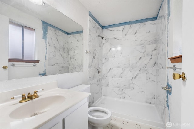 bathroom featuring vanity, toilet, and a stall shower