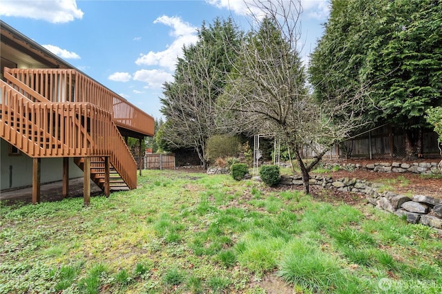 view of yard featuring stairs, fence, and a wooden deck