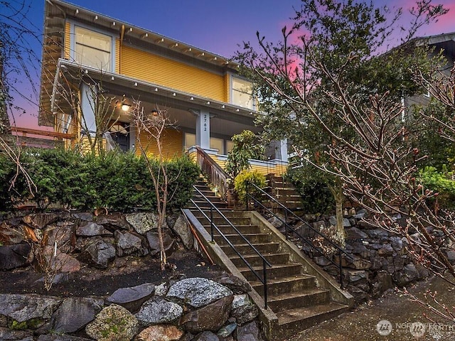 exterior space featuring stairway and a porch