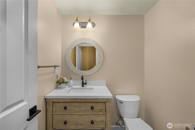 bathroom featuring toilet and vanity