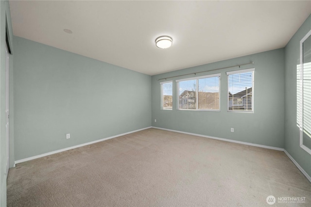 spare room with carpet floors and baseboards