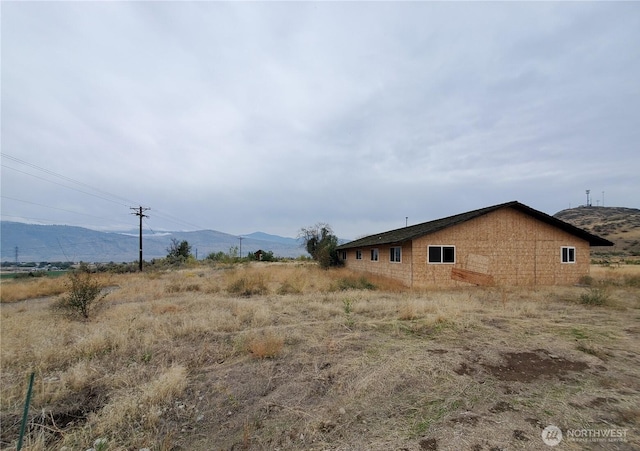 view of side of home featuring a mountain view