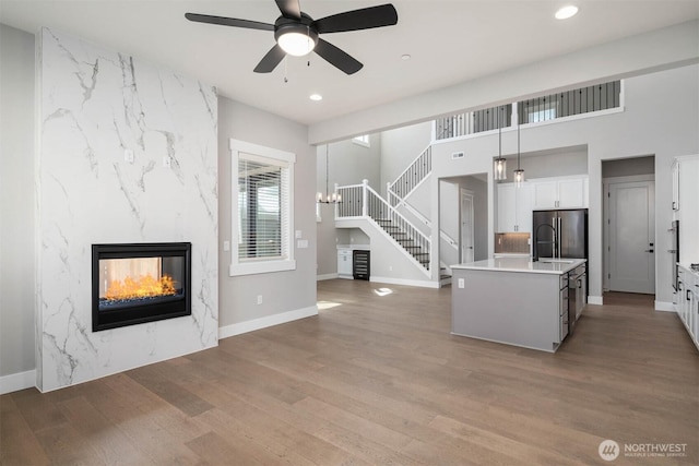 kitchen with ceiling fan, wood finished floors, white cabinets, freestanding refrigerator, and recessed lighting