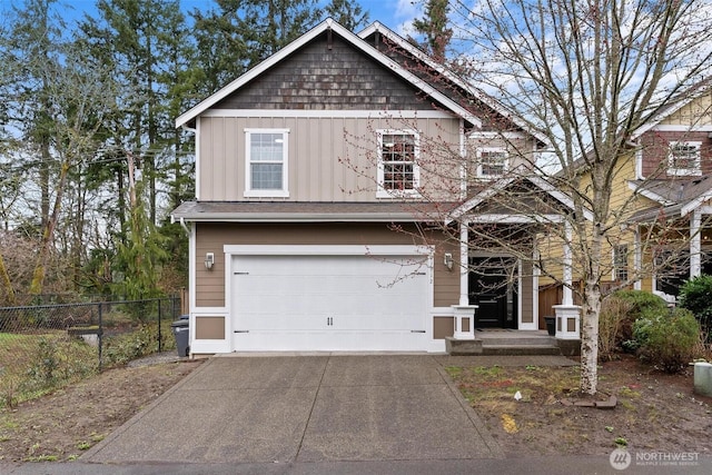 craftsman-style house with concrete driveway, a garage, fence, and board and batten siding