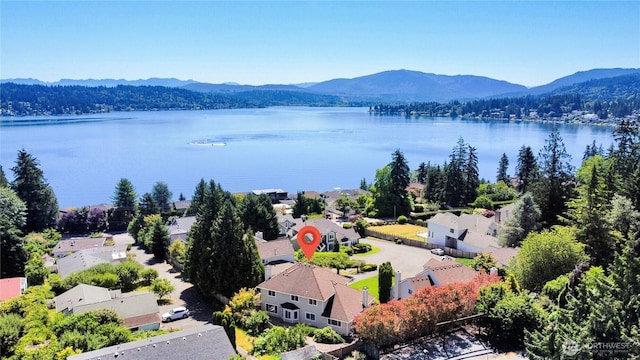 drone / aerial view featuring a water and mountain view