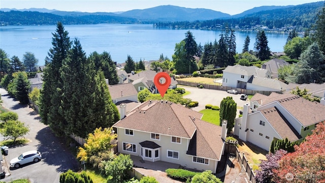 drone / aerial view featuring a residential view and a water and mountain view