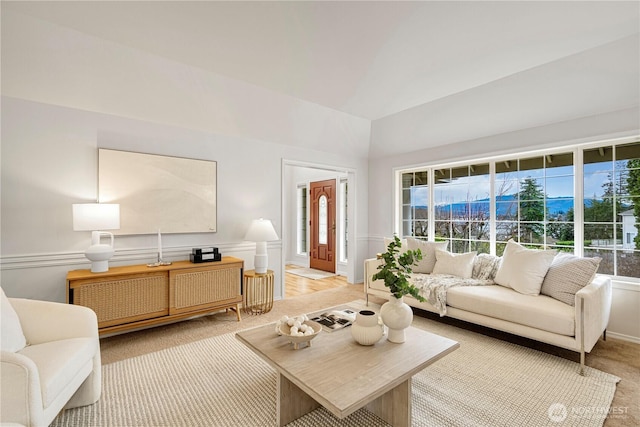 living area featuring plenty of natural light and light colored carpet