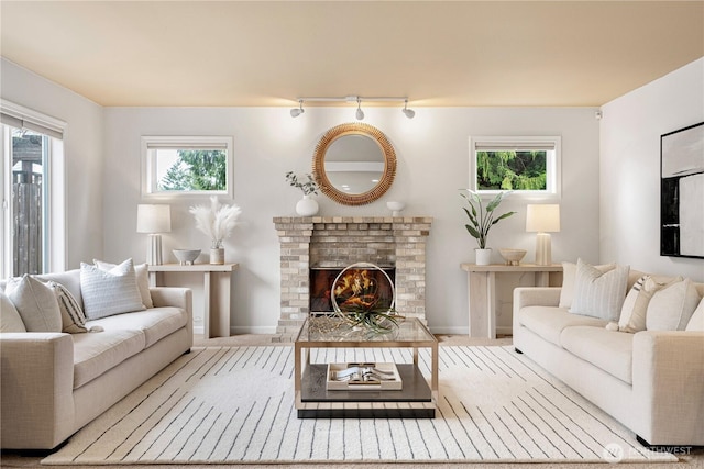 living room featuring baseboards and a fireplace