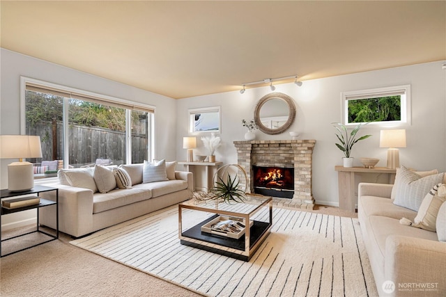 living area with a brick fireplace and carpet floors