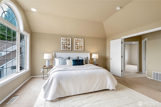 carpeted bedroom featuring visible vents, baseboards, and vaulted ceiling