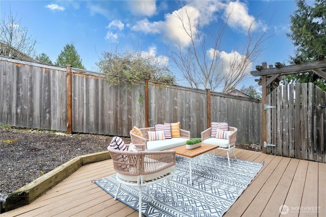 wooden deck featuring an outdoor hangout area and a fenced backyard