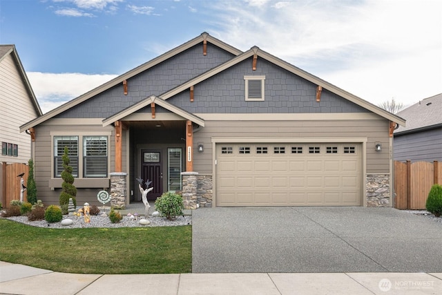 craftsman inspired home featuring stone siding, concrete driveway, and fence