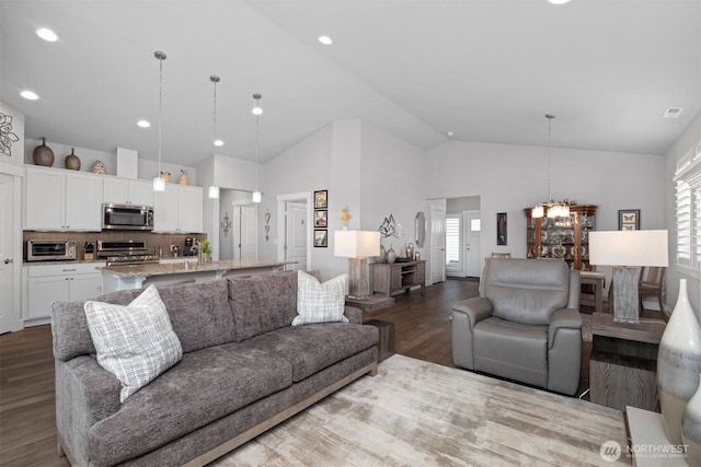 living room with recessed lighting, a toaster, visible vents, and wood finished floors