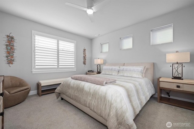 carpeted bedroom featuring baseboards, visible vents, and a ceiling fan