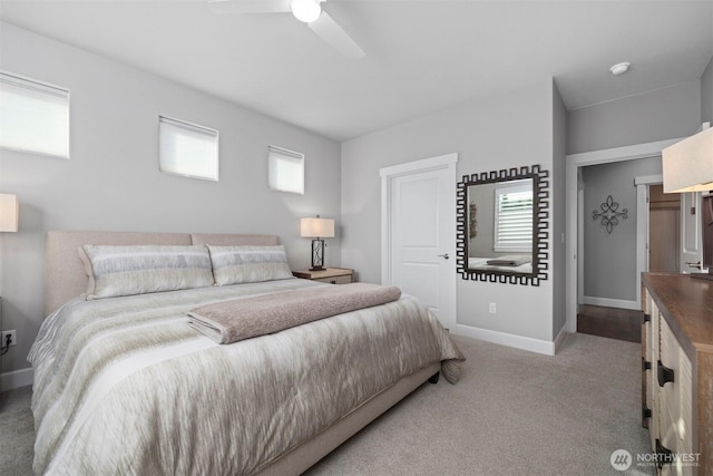 carpeted bedroom with a ceiling fan and baseboards