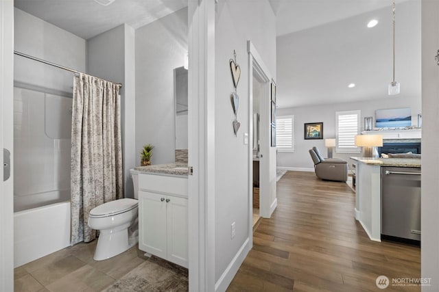 full bath with recessed lighting, toilet, shower / tub combo, vanity, and wood finished floors