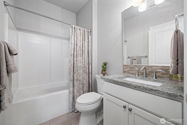 full bath featuring toilet, decorative backsplash, shower / bath combo, vanity, and tile patterned floors