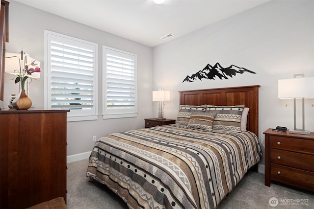 bedroom with carpet floors, visible vents, and baseboards