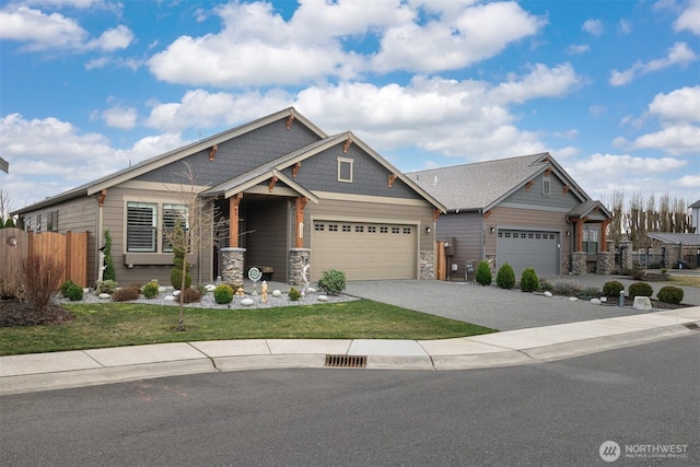 craftsman inspired home featuring driveway, stone siding, an attached garage, and fence