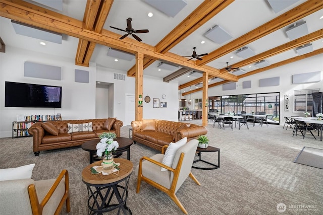 carpeted living room with a ceiling fan, beam ceiling, visible vents, and high vaulted ceiling