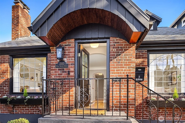 view of exterior entry with brick siding