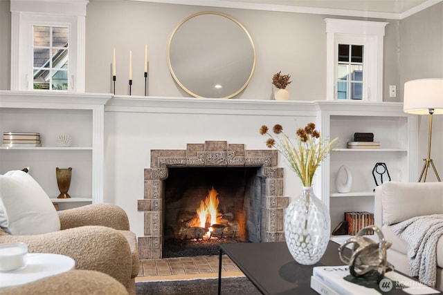 living area featuring a tile fireplace and built in features