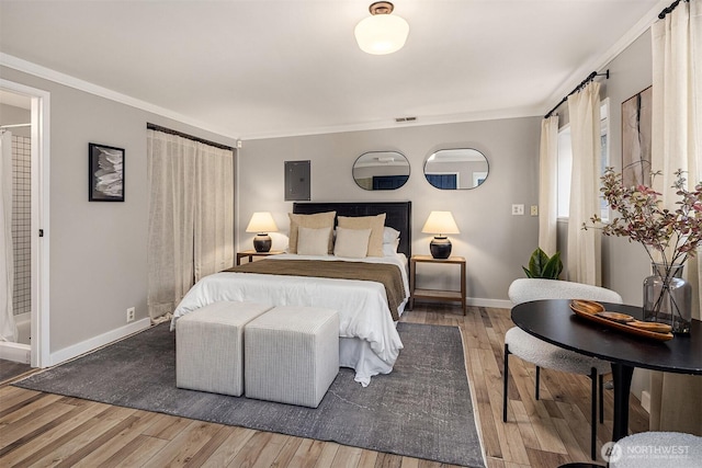 bedroom featuring wood-type flooring, visible vents, baseboards, and crown molding