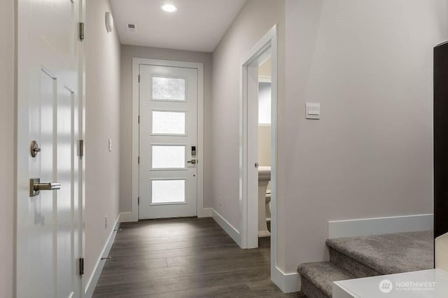 entryway featuring dark wood-style floors, visible vents, stairway, and baseboards