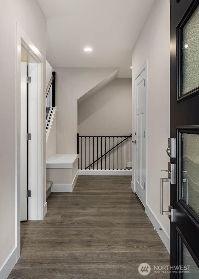 stairs featuring baseboards, wood finished floors, and recessed lighting