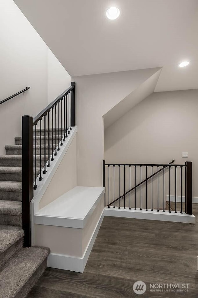 stairway with baseboards, wood finished floors, and recessed lighting