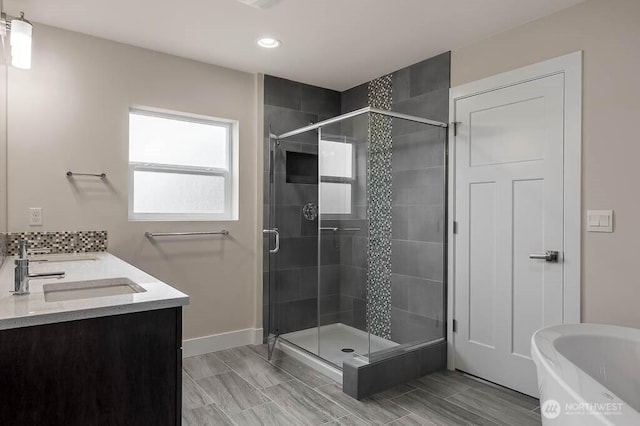 bathroom with a sink, a shower stall, and a bathing tub