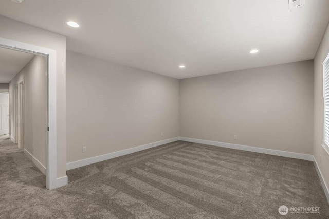 carpeted spare room featuring recessed lighting, visible vents, and baseboards