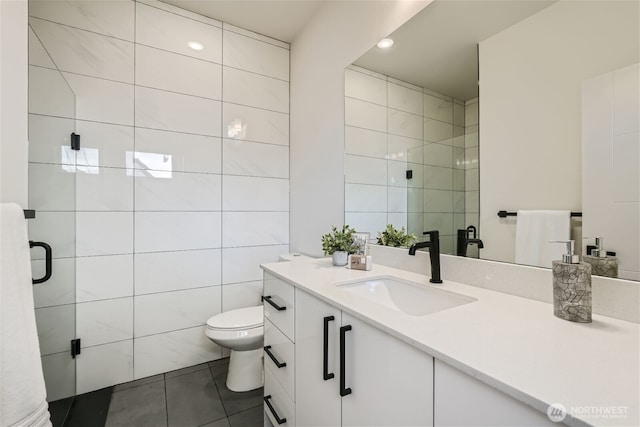 full bathroom with toilet, tile patterned flooring, vanity, a shower stall, and tile walls