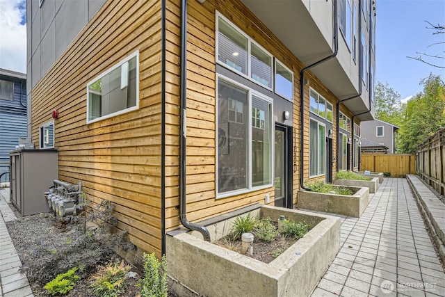 view of home's exterior with a vegetable garden and fence