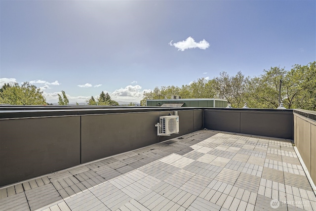 view of patio / terrace featuring ac unit and a balcony