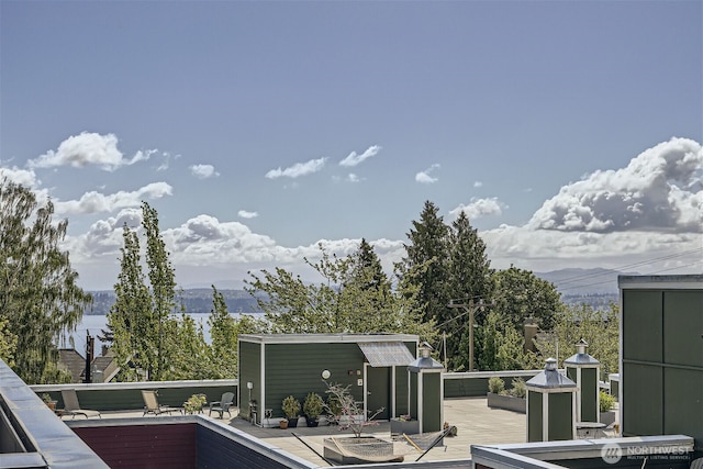 wooden terrace featuring a mountain view and an outdoor structure