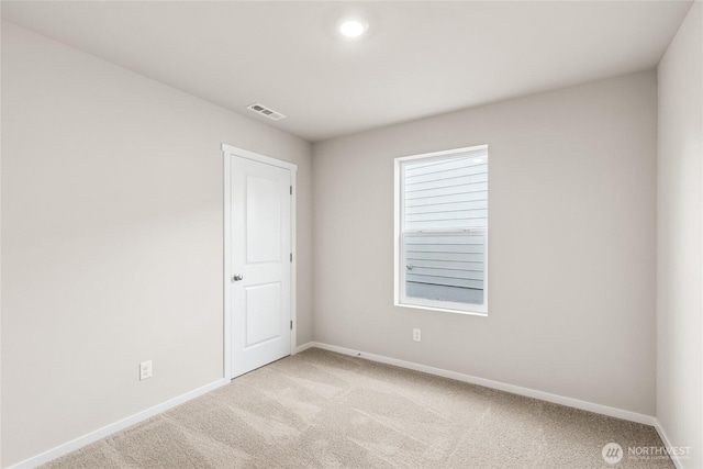 unfurnished room with light carpet, baseboards, and visible vents