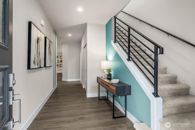 hallway with stairway, recessed lighting, dark wood finished floors, and baseboards