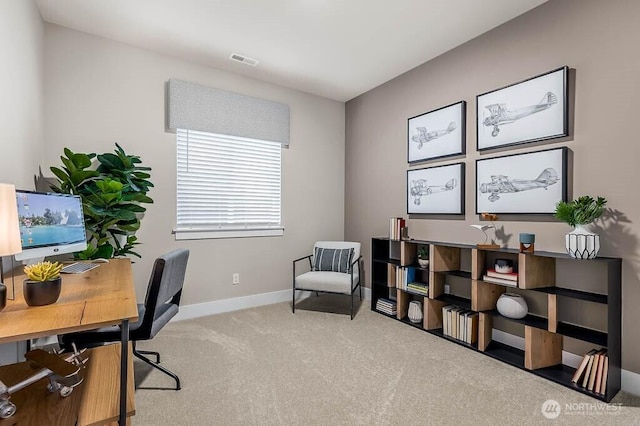 carpeted home office featuring visible vents and baseboards