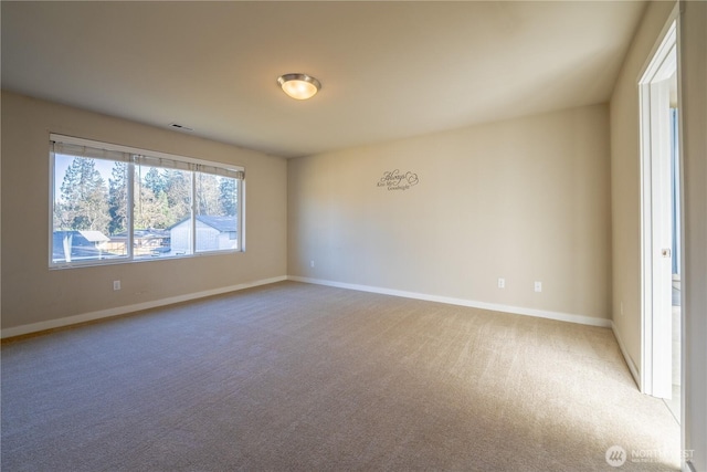 carpeted spare room with baseboards and visible vents