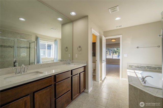 bathroom with a sink, visible vents, toilet, and a shower stall