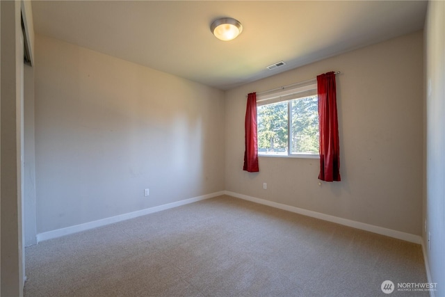 unfurnished room featuring visible vents, carpet flooring, and baseboards