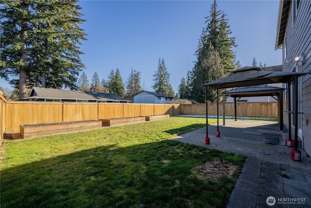 view of yard featuring a gazebo, a patio area, and a fenced backyard