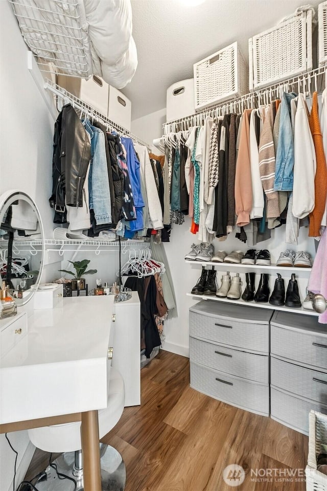 walk in closet featuring wood finished floors