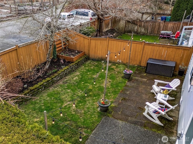 view of yard with a fenced backyard and a vegetable garden