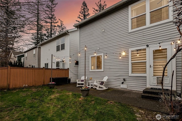 back of house featuring a yard, a patio area, and fence