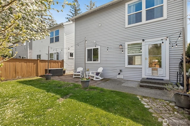 back of house with a patio, fence, and a lawn