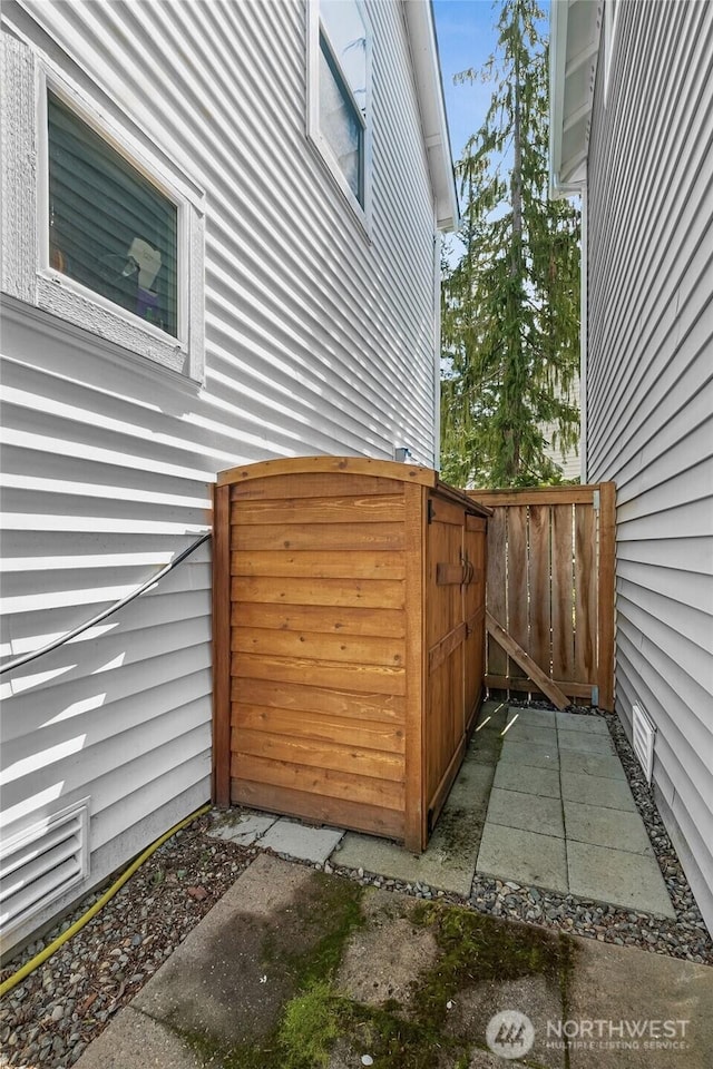 view of side of property featuring fence