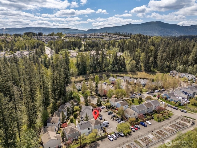 aerial view featuring a view of trees, a residential view, and a mountain view