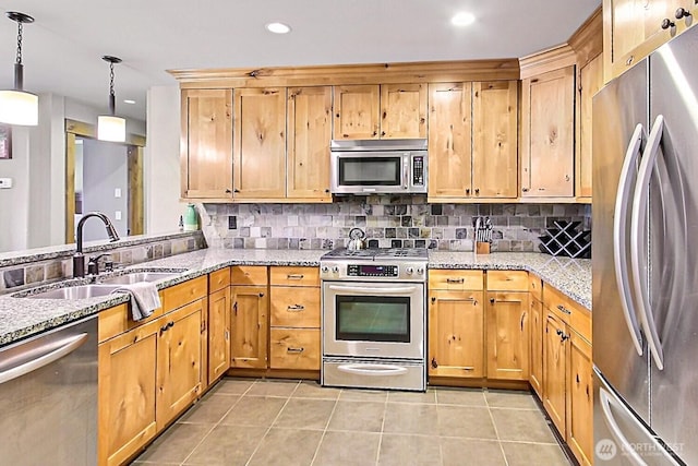 kitchen featuring light tile patterned floors, appliances with stainless steel finishes, backsplash, and a sink